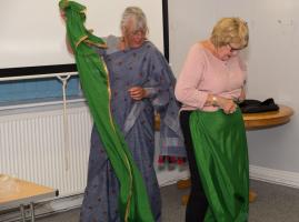 Dr Hardy dressing Pres. Ray in a Sari