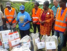 Members from the Rotary Club of Monrovia donate essential items to families quarantined by Ebola 