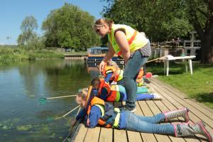 Children 'pond-dipping' to learn about creatures living in the River Stour.