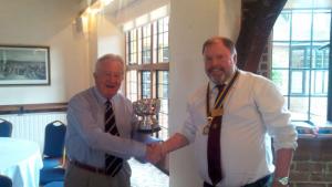 Mike Gibbs being presented with the trophy for winning the bowling tournament