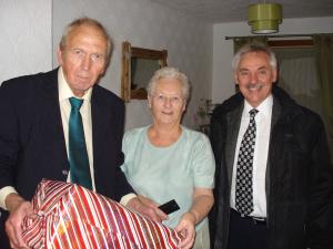 Picture shows Christmas Hamper winner Mrs Wilson with Rotarian Chris Simmonds (L) and Rotary Vice President and fireworks technician Ian Morrison.  