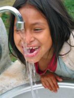 ﻿Clorinda Palomina, 8, drinks from an outdoor sink in the village of Santa Rosa de Huacaria, Peru, built with the help of a District Simplified Grant.
