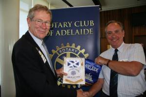 George exchanging club banners with the President of Adelaide Rotary, Chris Michelmore.