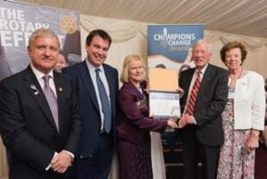 George Mercer receives his award from Rotary RGBI President Eve Conway watched by, from left, District Governor Steve Jenkins, Cardiff North MP Craig Williams and Joan Mercer