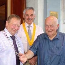 Picture shows President Gordon receiving his chain of office from outgoing President Derek. Looking on is incoming Vice-President Ian Morrison.