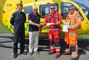 Basingstoke Loddon Rotary Club President, Ian Rosewell, presenting a £2,500 cheque to Crew Members of the Air Ambulance