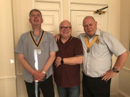 Outgoing club president Chris hands over the reins to incoming president Graeme and president-elect Tony.