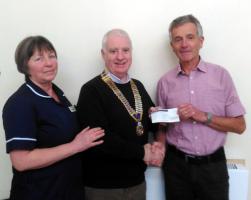 President Andy Carter presents the initial donation to  Dr Jonathan Nicoll and Sister Dawn Sanderson.