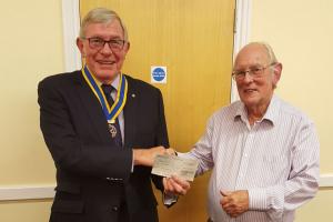 Club President Steve Knight presents a donation to David Tamcken