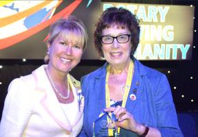 Past President Gill Norton accepts the trophy from Rotary International  Vice-President Jennifer Jones