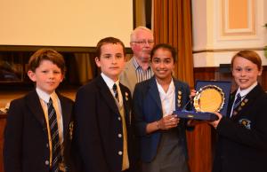 Hutcheson's Grammar team with their trophy - District Governor Elect William Campbell in the background.