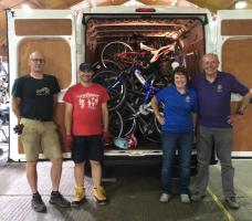 Rotarians Jackie Wellman and Bob Taylor with Re~Cycle volunteers and the latest bike collection
