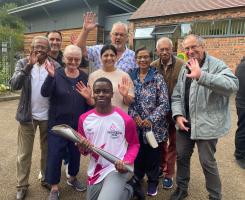 Members with the baton and one of the inspirational carriers