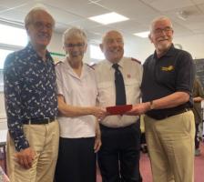 President Arthur and Cliff present Margaret and Malcolm with a card and farewell gift.