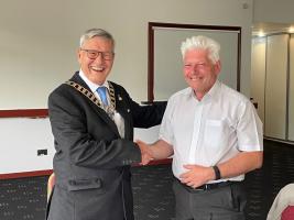 New President Robert Dickie being welcomed by Past President Nigel Wunsch