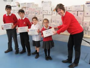 President Kath Nurse receiving shoexes from Falkland School pupils