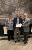 'President Moray Bisset presents a Paul Harris Fellowship Award to the Rev. Trevor Grewcock.'