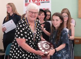 Seaford Rotary President Ann Reed presenting the Colin Seymour Shield to violinist Isobel Peerless