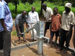 Villagers inspect the well head