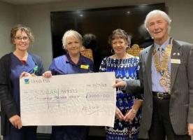 President Brian Bates and organiser Maria Pulley present the cheque