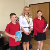 Yvonne with 2 year 6 pupils receiving their dictionaries 