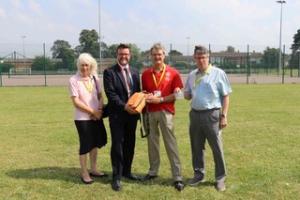 Rotarians presenting the defibrillator to Principle Dermot McNiffe