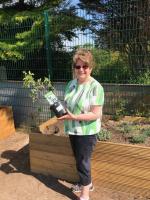 President Ros with some of the plants 
we had donated for the garden.