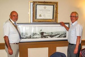 Andrew Slater (r), and Bob Guard(l), President of the Rotary Club, in front of a picture of the SS Lusitania docked in New York harbour the year before her final voyage.