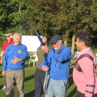 Brian Cockrell, Jack Skillicorn and Paul Soni instructing Roger Saunders in which way the bow points.