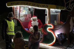 Santa greeting some excited children
