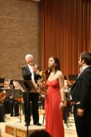 Soloist Horn player Anna Douglas and Tenor Stuart Jackson being applauded by Conductor Leon Lovett
