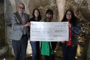 Paul Vaesen (Chair of Youth Services Committee) (on left) and Mandy Davis (Vice President) (on right) presenting the donation to Sophie Peerless and Alice Carter from SCIP.