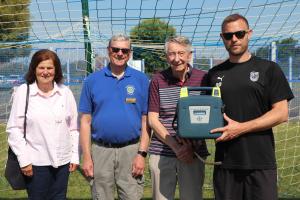 Linda Wallraven, Chair of Youth Services Paul Vaesen and Jim Anderson presenting the defibrillator to Dave Peachey from Seaford Town FC