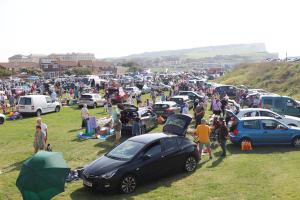 Cars parked by stallholders in three impromptu rows