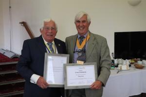 Vice President Clive Livingstone presenting Tony Lees with certificate to commemorate his long uninterrupted 50 years of service, and a framed congratulatory letter from Gordon McInally, President Rotary International 2023/24