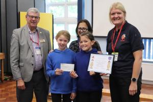 Two Iford and Kingston Primary school pupils who took part in Safety in Action with the cheque and certificate with Paul Vaesen, chair Seaford Rotary Youth Services committee, Head teacher Catherine Allison and Elaine Winks, Youth Engagement Officer