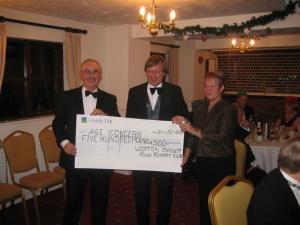 President Philippa Lawrence present cheque to Age Concern Committee member Ray James (left) with Community Chair Steve Walls (centre) in attendance