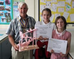 President Clive Livingstone holding the winning construction with Rowan and Gabi ,two members from the winning team from Chyngton Primary school