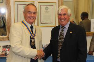 Immediate Past President Clive Livingstone congratulating President Mike Barker.