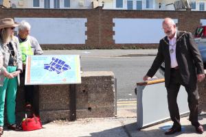 Councillor Rodney Reed, Mayor of Seaford officially opening the storm gate leading to the town centre watched by Rotarian Clive Livingstone who installed the gate.