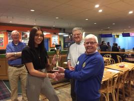 Clive Williams handing the trophy to  Goda Norvilaite, President of Springwood High School Interact Club.