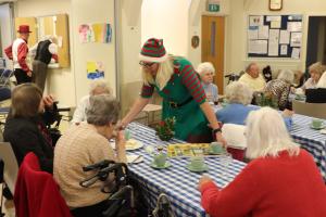 Mary Hawes serving refreshments to the party guests