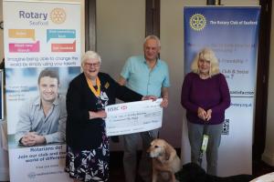 Vice President Ann Reed presenting the donation cheque to Mick Etheridge with Onyx and Pam Byrne with Poppy