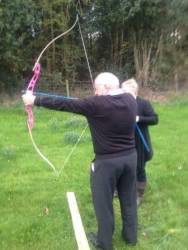 Secretary John takes careful Aim!