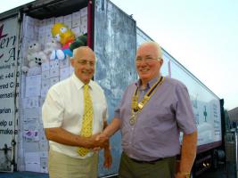 Rotarian Jim Houghton and President of the Rotary Club of Southport Links Bill Thomas, with a lorry load of shoeboxes (and Bart Simpson)