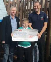 Rotary President John New presents a cheque to Joseph Curry and Gareth Hywel