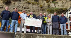 Shanklin Rotary Club President, Steve Knight, presents the cheque for £4,000 to Lifeboat crew members.