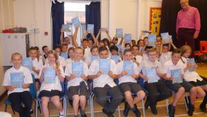 Children in Year 6 at Little Heath School receive their Usborne Dictionaries from Brookmans Park Rotary Vice President Alan Rice-Smith.