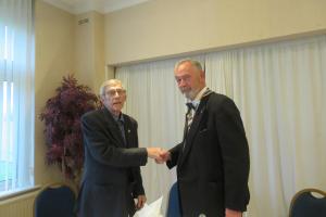 Geoff Gander (left), hands over to Roger Young (right)