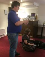 Mark Jones addressing members of Rotary Club with his wife Natalie and Natalies’ guide dog Sidney seated